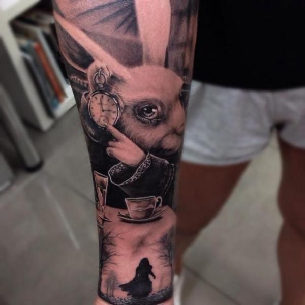 Natural looking colored rabbit from Alice in wonderland tattoo on forearm