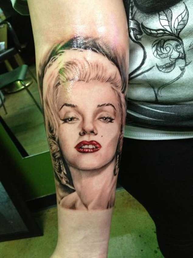 Natural looking colored sexy Merlin Monroe portrait tattoo on forearm