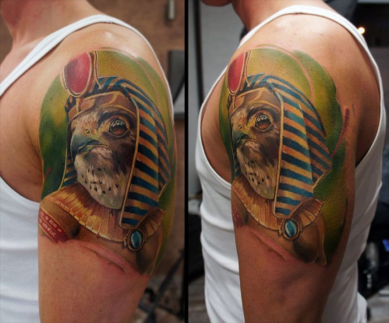 Natural looking colored shoulder tattoo of ancient Egypt God