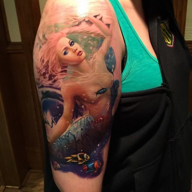 Natural looking colored shoulder tattoo of sexy mermaid with fishes