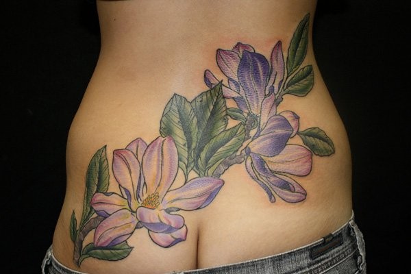 Natural looking colored waist tattoo of violet flower with leaves