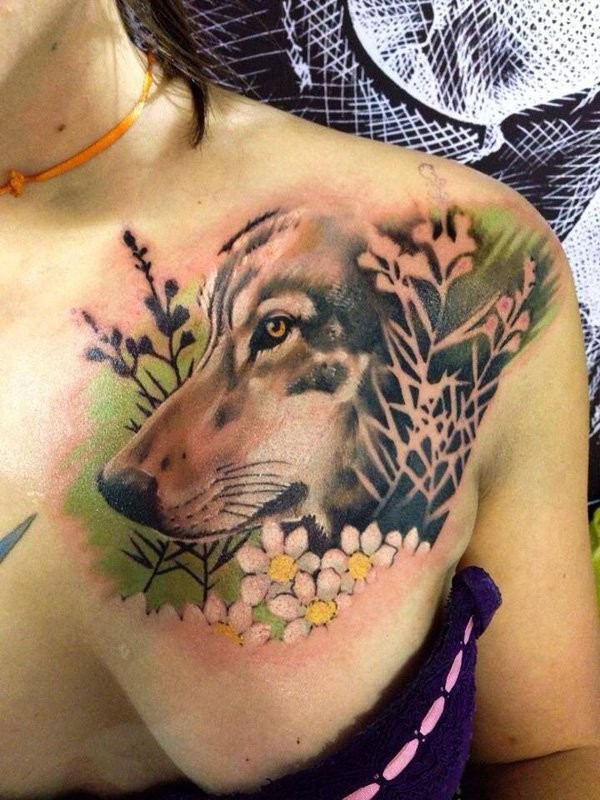 Natural looking detailed colored wolf tattoo on chest combined with beautiful flowers