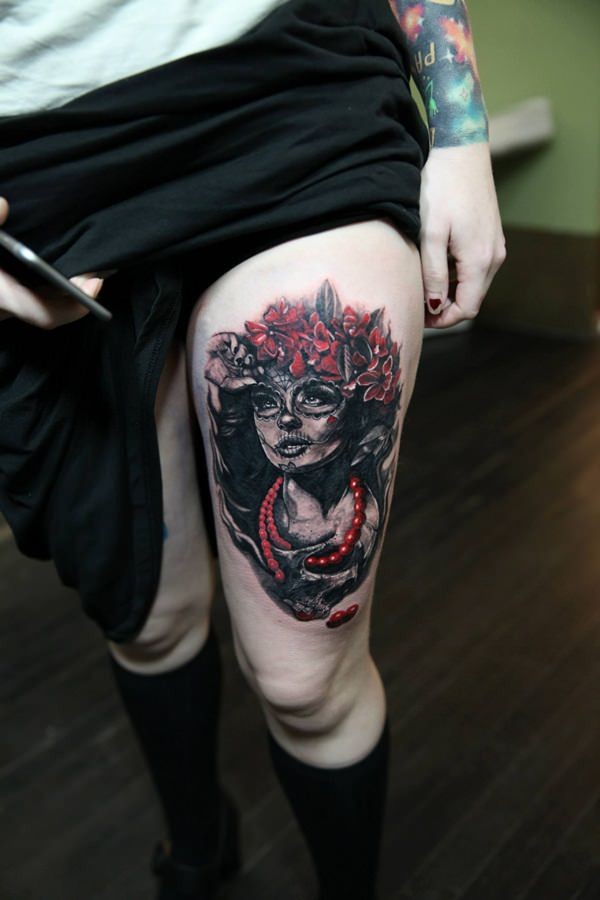 Natural looking gorgeous painted colored woman portrait tattoo on thigh stylized with flowers