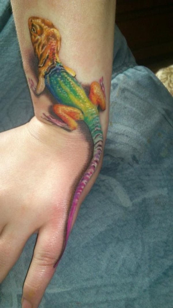 Natural looking multicolored realism style lizard tattoo on wrist