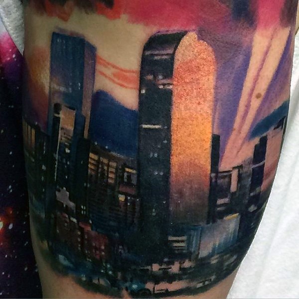Natural looking multicolored realistic night city tattoo on thigh