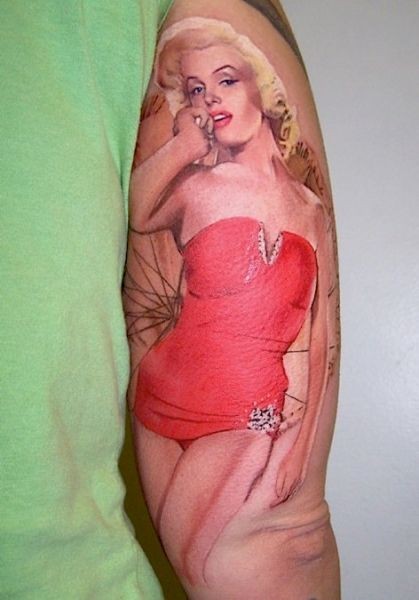 Natural looking red colored Merlin Monroe tattoo on arm