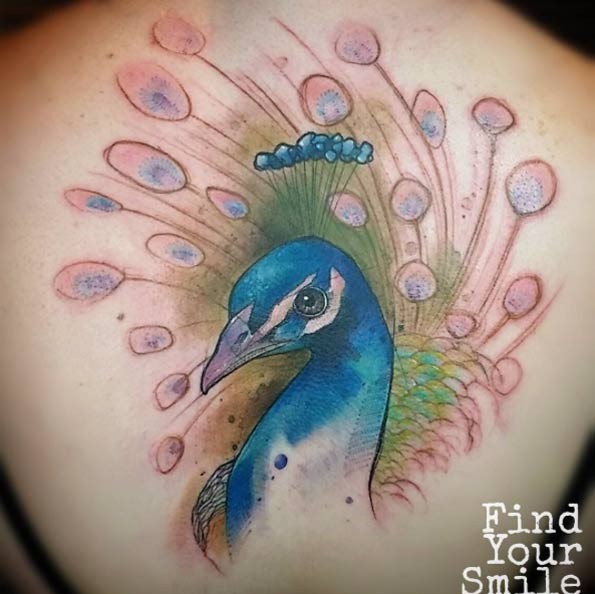 Natural looking very beautiful whole back tattoo of peacock