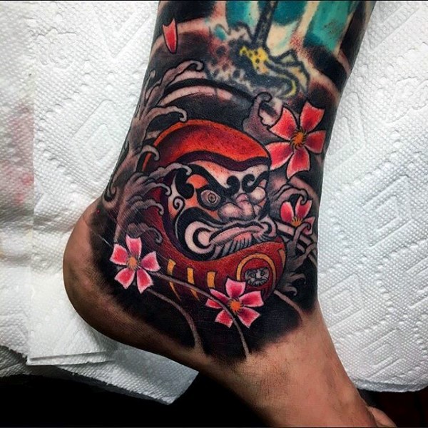 Neo japanese style colored  ankle tattoo of daruma doll with flowers