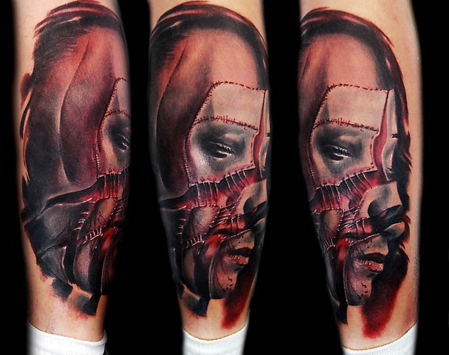 Neo traditional style colored arm tattoo of ripped mans face