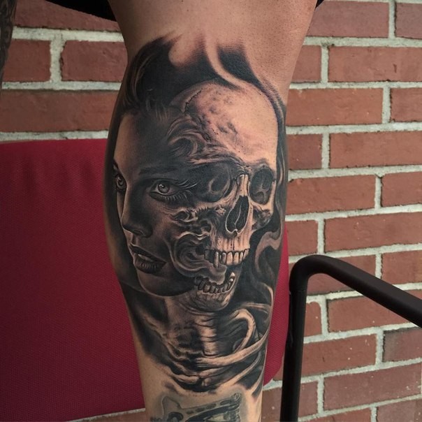 Neo traditional style colored biceps tattoo of woman face with skull