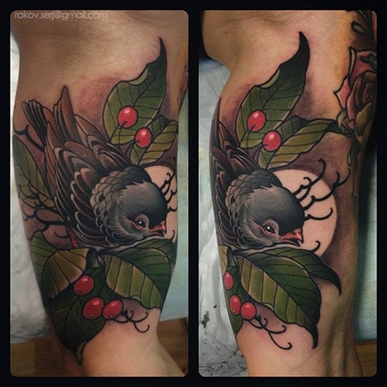 Neo traditional style colored biceps tattoo of little bird with berries