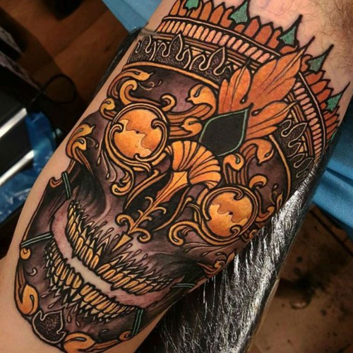Neo traditional style colored biceps tattoo of creepy mask