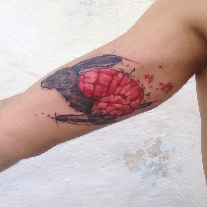 Neo traditional style colored biceps tattoo of rabbit with human brain