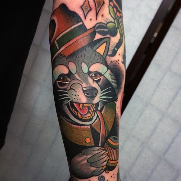 Neo traditional style colored forearm tattoo of raccoon with smoking pipe