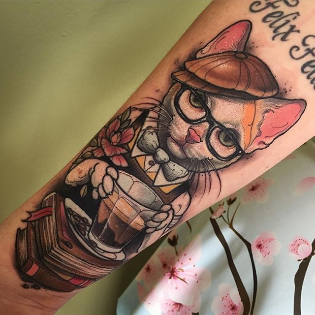 Neo traditional style colored forearm tattoo of cute cat with cap and books