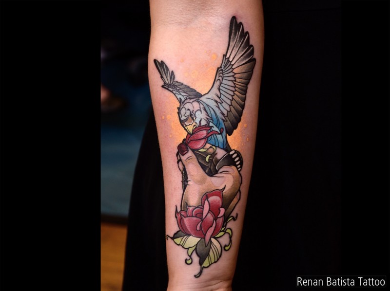 Neo traditional style colored forearm tattoo of small owl with woman hand and rose