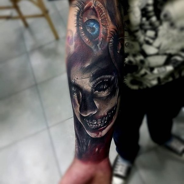 Neo traditional style colored forearm tattoo of creepy zombie woman with eye
