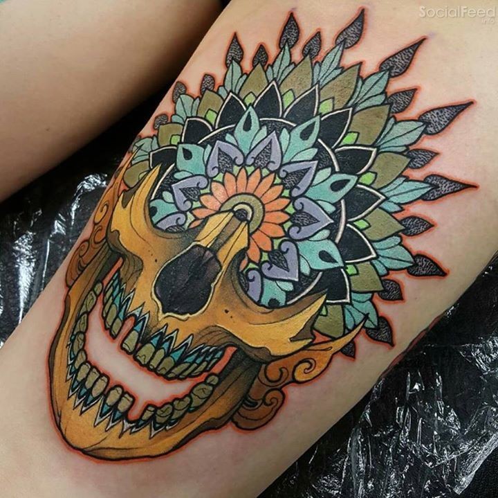 Neo traditional style colored tattoo of human skull part with flowers