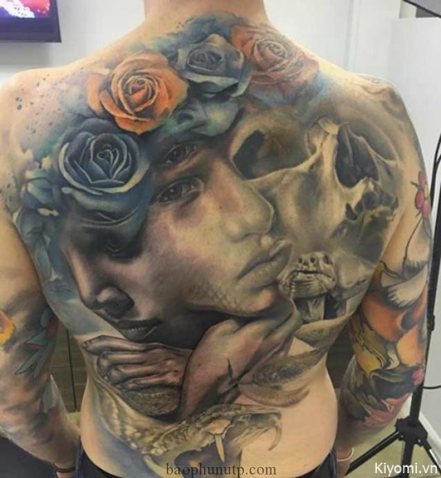 Neo traditional style colored whole back tattoo of woman face with skull and roses