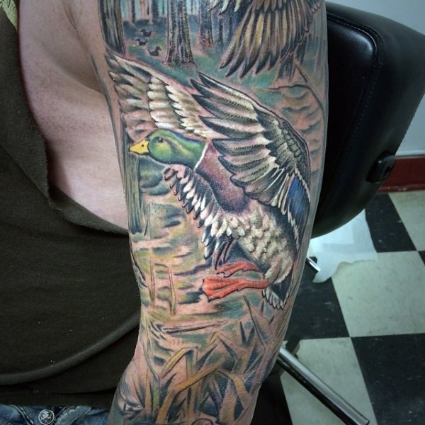 New school illustrative style colored sleeve tattoo of ducks in forest
