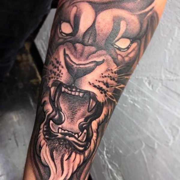 New school illustrative style forearm tattoo of lion face