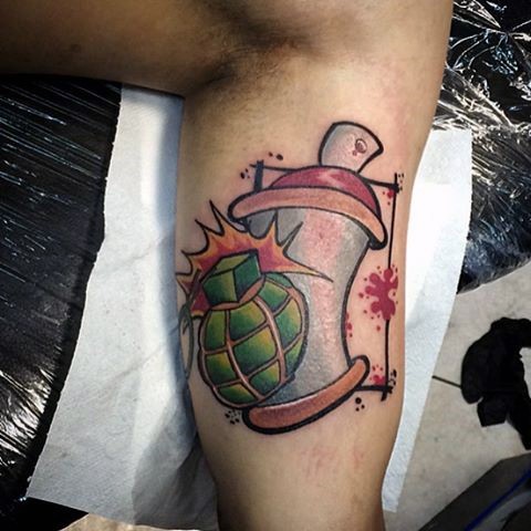 New school style arm tattoo of grenade with spray paint