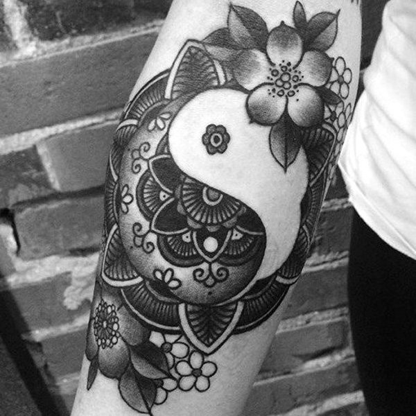 New school style black ink arm tattoo of Yin Yang symbol stylized with flowers