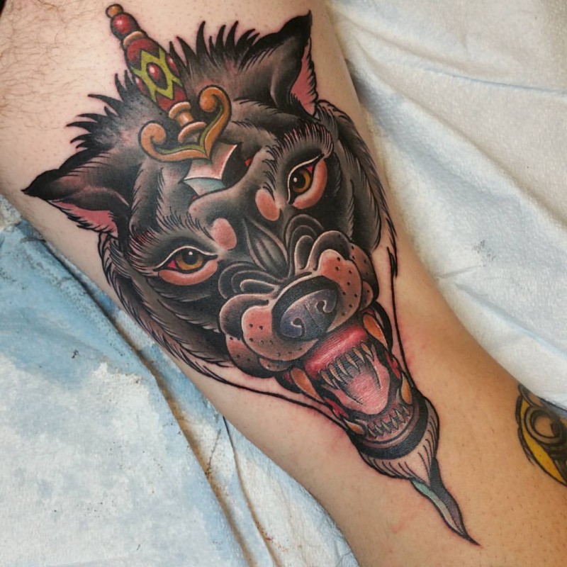 New school style colored ankle tattoo of demonic dog with antic dagger