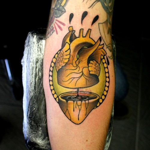 New school style colored arm tattoo of interesting looking human heart