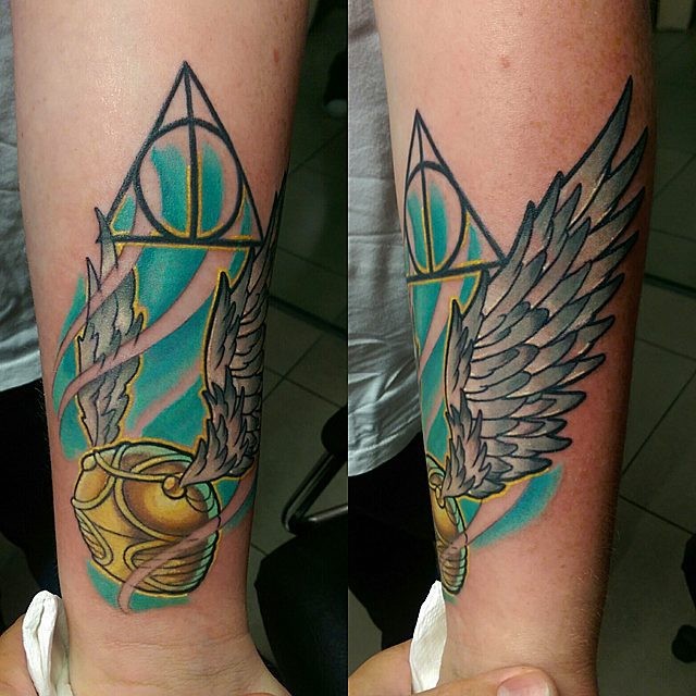 New school style colored arm tattoo of quiddich ball with wings