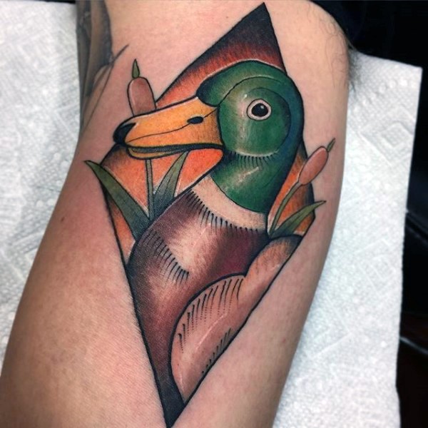 New school style colored arm tattoo of duck in reed