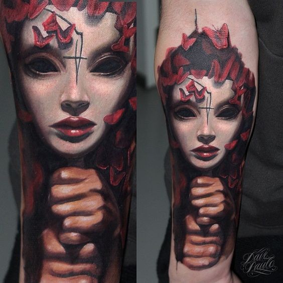 New school style colored arm tattoo of demonic woman face with butterflies