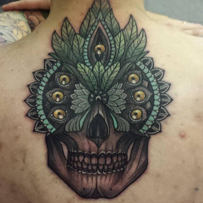 New school style colored back tattoo of human skull stylized with feather
