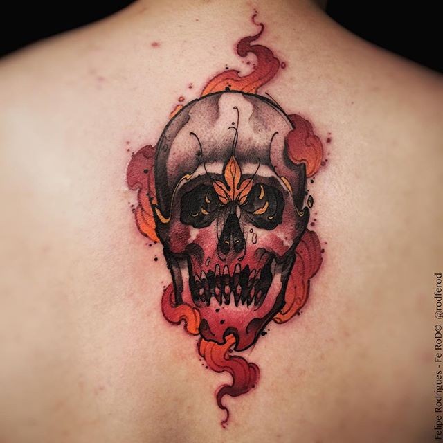 New school style colored back tattoo of skull with flames and leaves