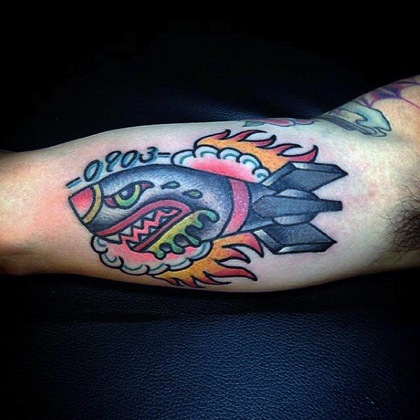 New school style colored biceps tattoo of funny bomb