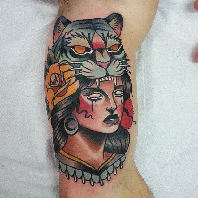 New school style colored biceps tattoo of woman with tiger helmet and rose