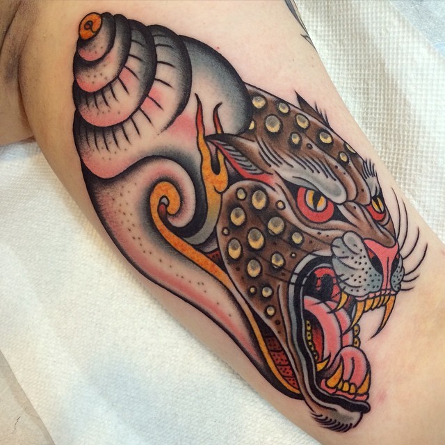 New school style colored biceps tattoo of monster tiger face with shell