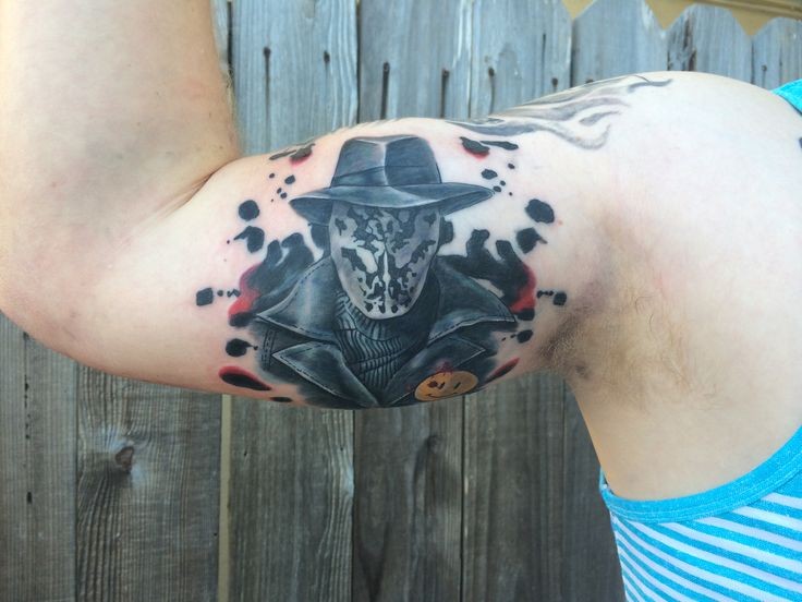 New school style colored biceps tattoo of Rorschach portrait