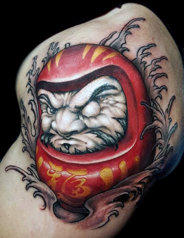 New school style colored biceps tattoo of daruma doll with waves