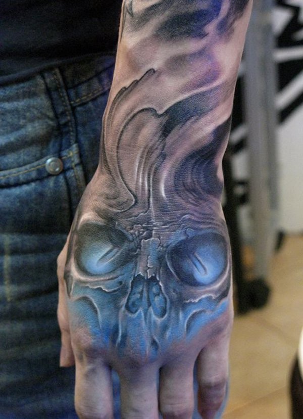 New school style colored demonic blue colored human skull tattoo on hand