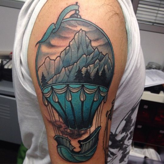 New school style colored fantasy flying balloon tattoo on shoulder stylized with mountains and forest