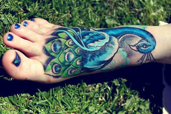 New school style colored foot tattoo of blue peacock