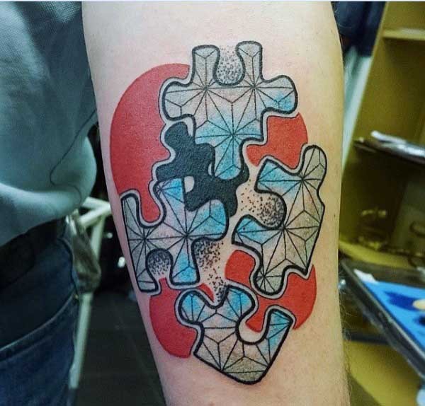 New school style colored forearm tattoo of puzzle pieces