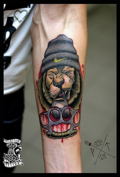 New school style colored forearm tattoo of thigh dog with brass knuckles