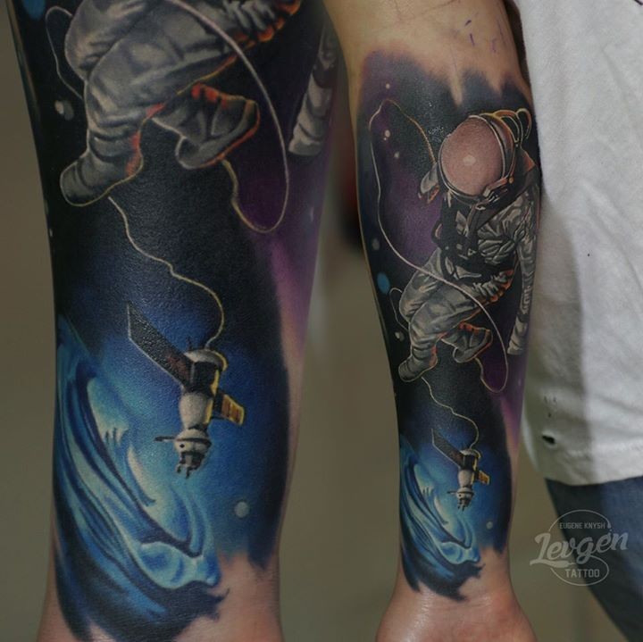 New school style colored forearm tattoo of man in space