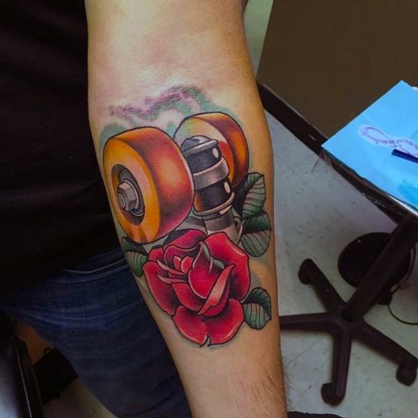 New school style colored forearm tattoo of skateboard wheels and rose flowers