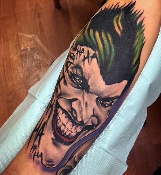 New school style colored forearm tattoo of evil Joker