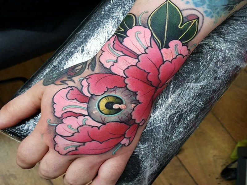 New school style colored hand tattoo of beautiful flower with eye