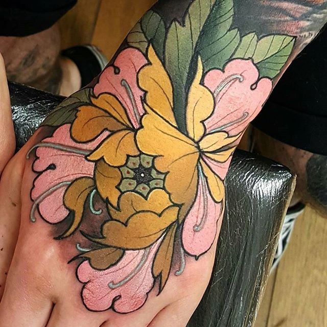 New school style colored hand tattoo of big flower