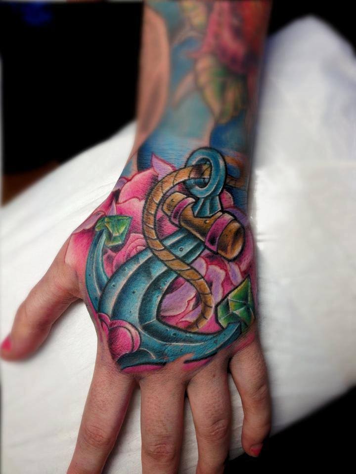 New school style colored hand tattoo of roped anchor with hearts